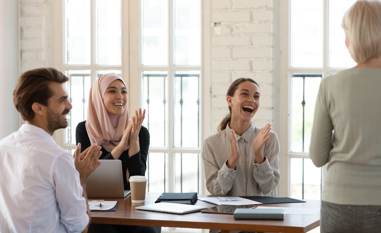 Colleagues celebrating and applauding