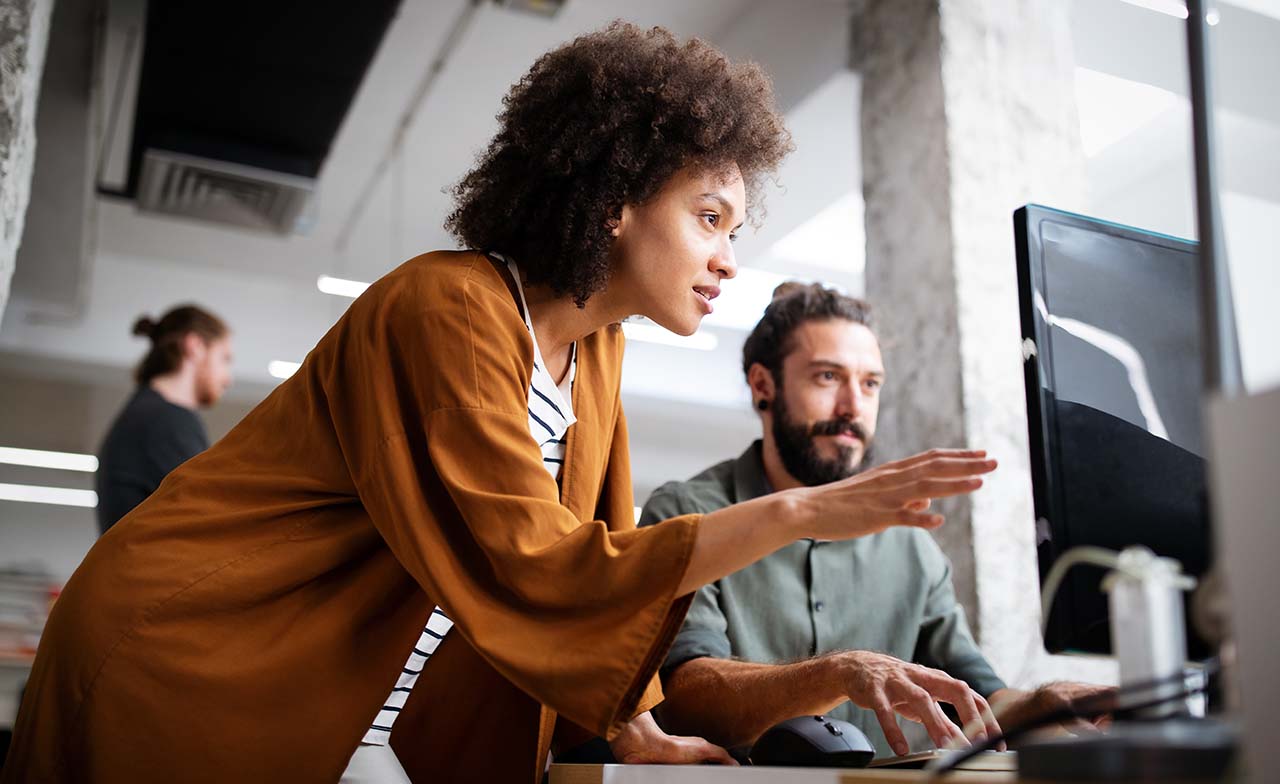 Two consultants in a strategy meeting at a desk