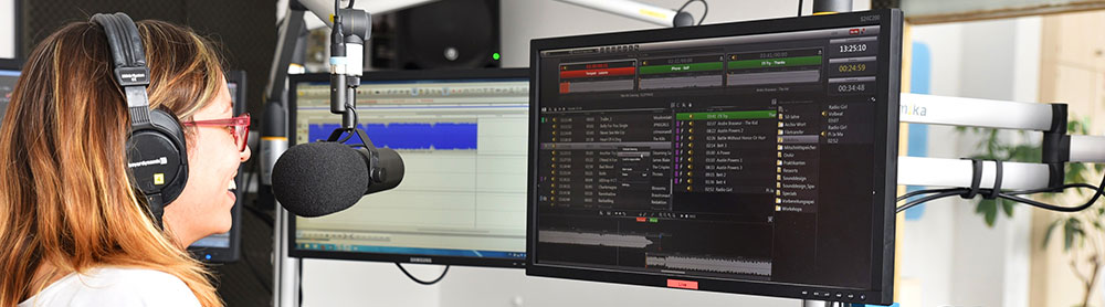 Person wearing headphones speaking into microphone