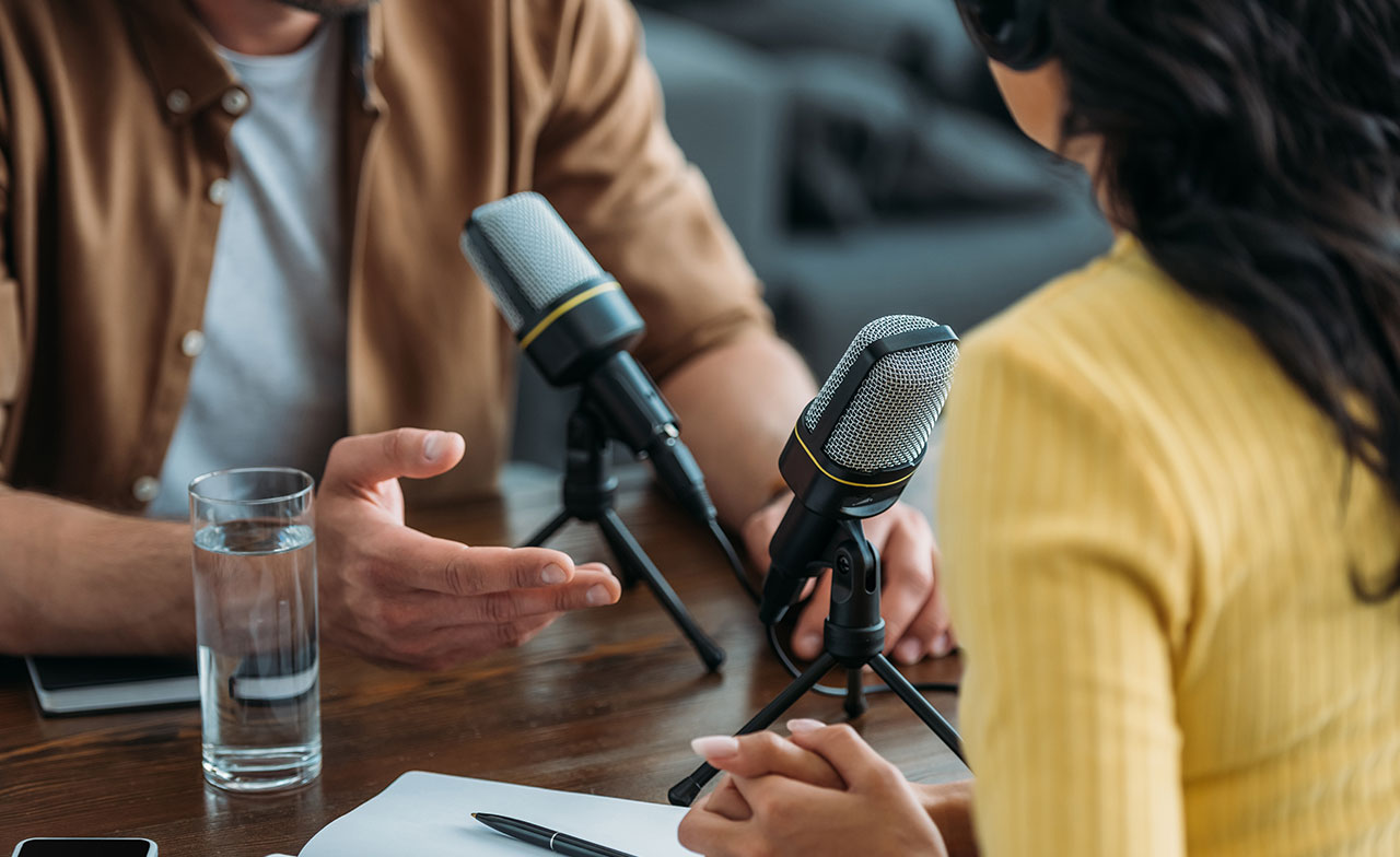 Two people taping a podcast