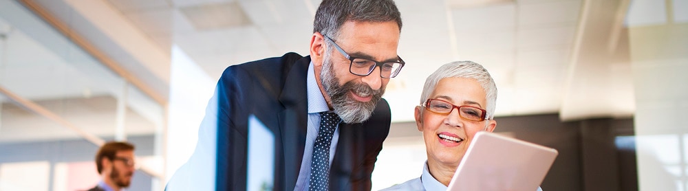 Two professionals looking at tablet screen 