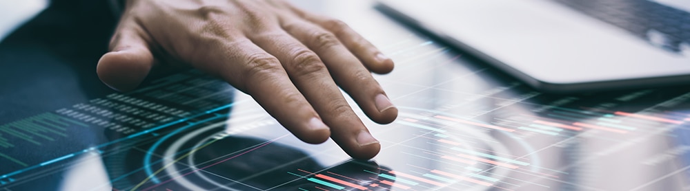Close up of hand using a touch screen data dashboard