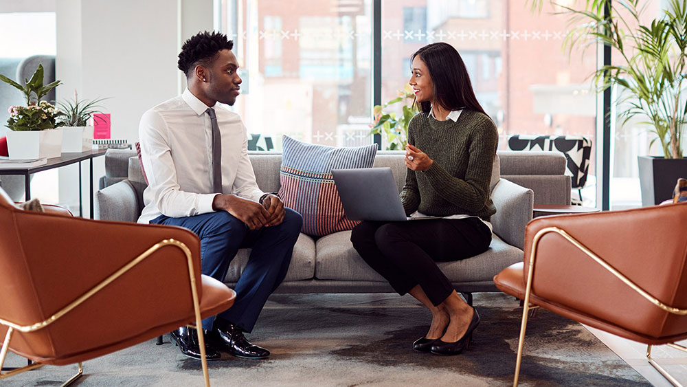 two-people-sitting-with-laptop