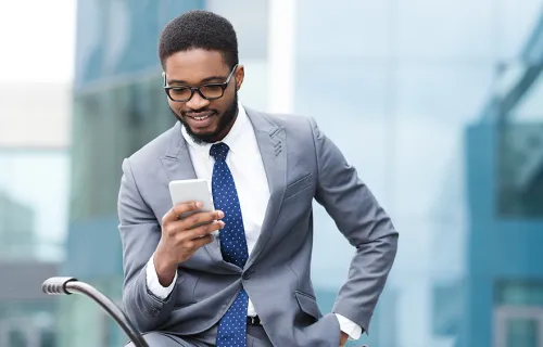 businessman on mobile phone in front of building