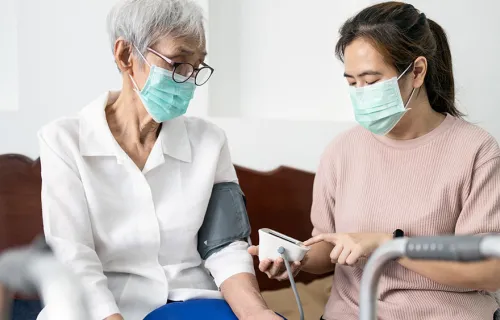 Healthcare professional checking pulse rate for patient