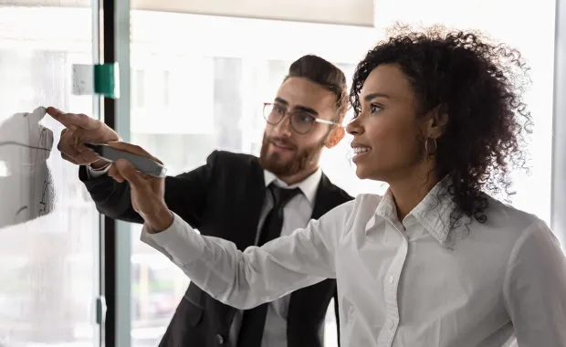 Collegues writing on a board
