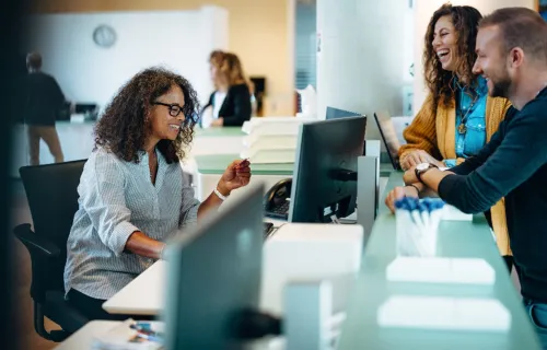 Consultant assisting customers at a public desk