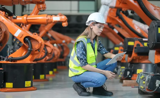 Female engineer working at AI robotic factory