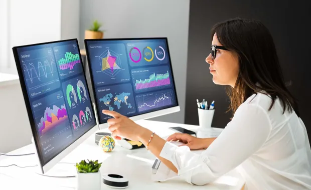 Consultant working on multiple screens