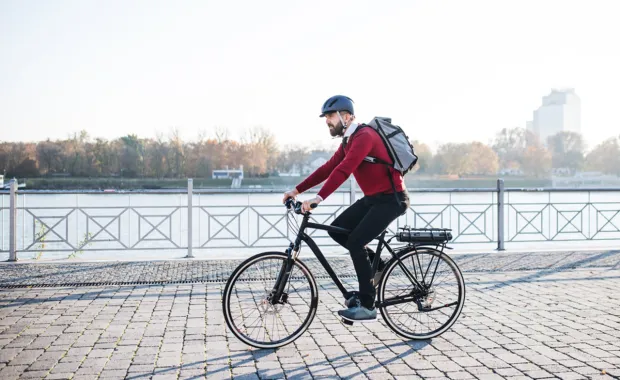 Man riding an electric bike with helmet on