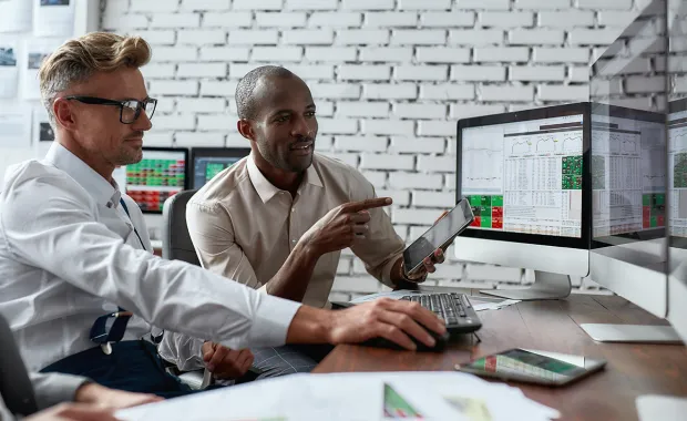 Two adults reviewing financial reports in an office