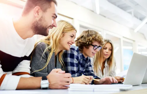 Students studying in front of laptop