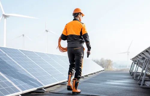 utilities worker check solar panels on a roof 