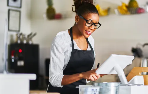 business owner using payment solution in coffee shop